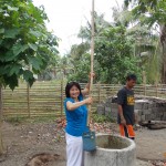 Kimberly Demars draws water from a well in Binalbagen School in the Philippines